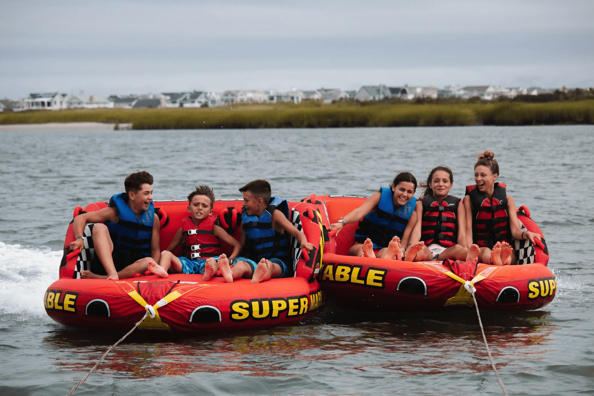Two tubes side-by-side being pulled by Island Water Sports — only operation on the Jersey Shore that runs two tubes at once