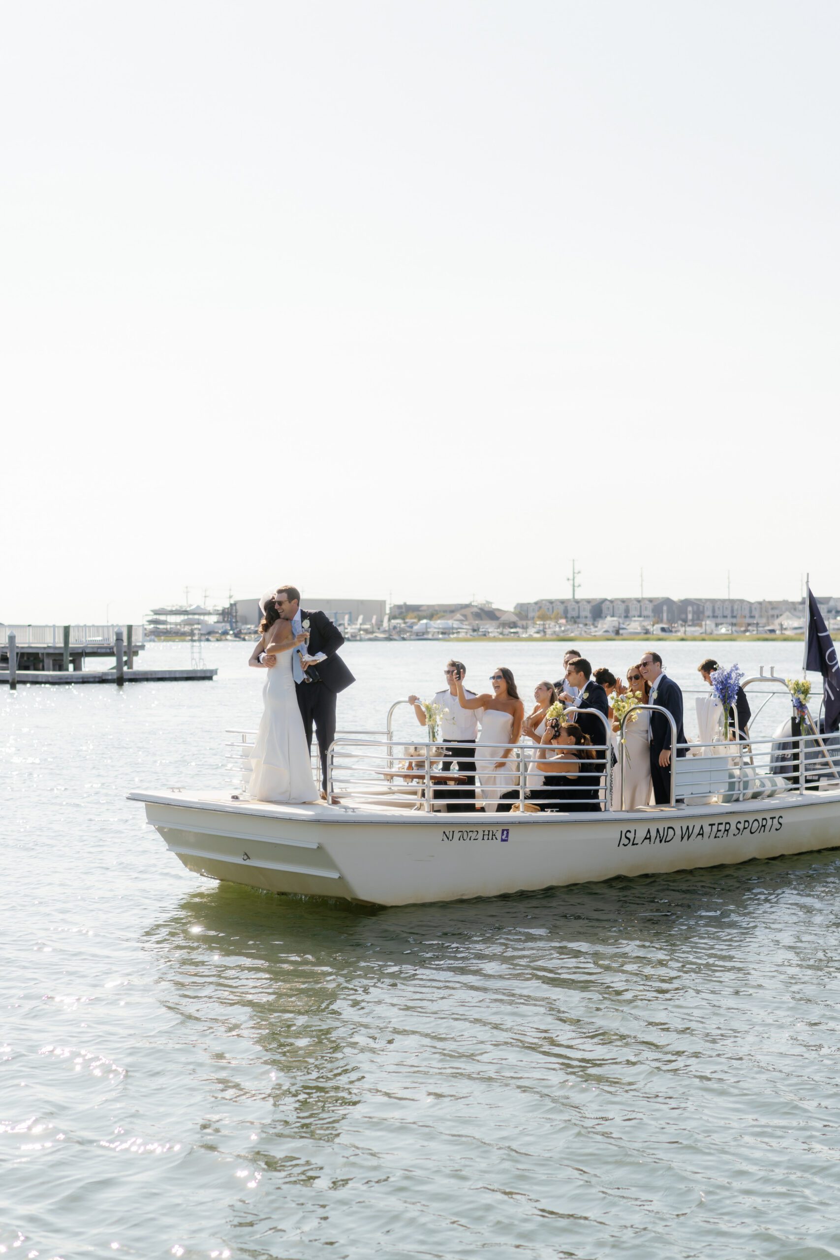 Wedding party gathered on a boat for a private event with IWS