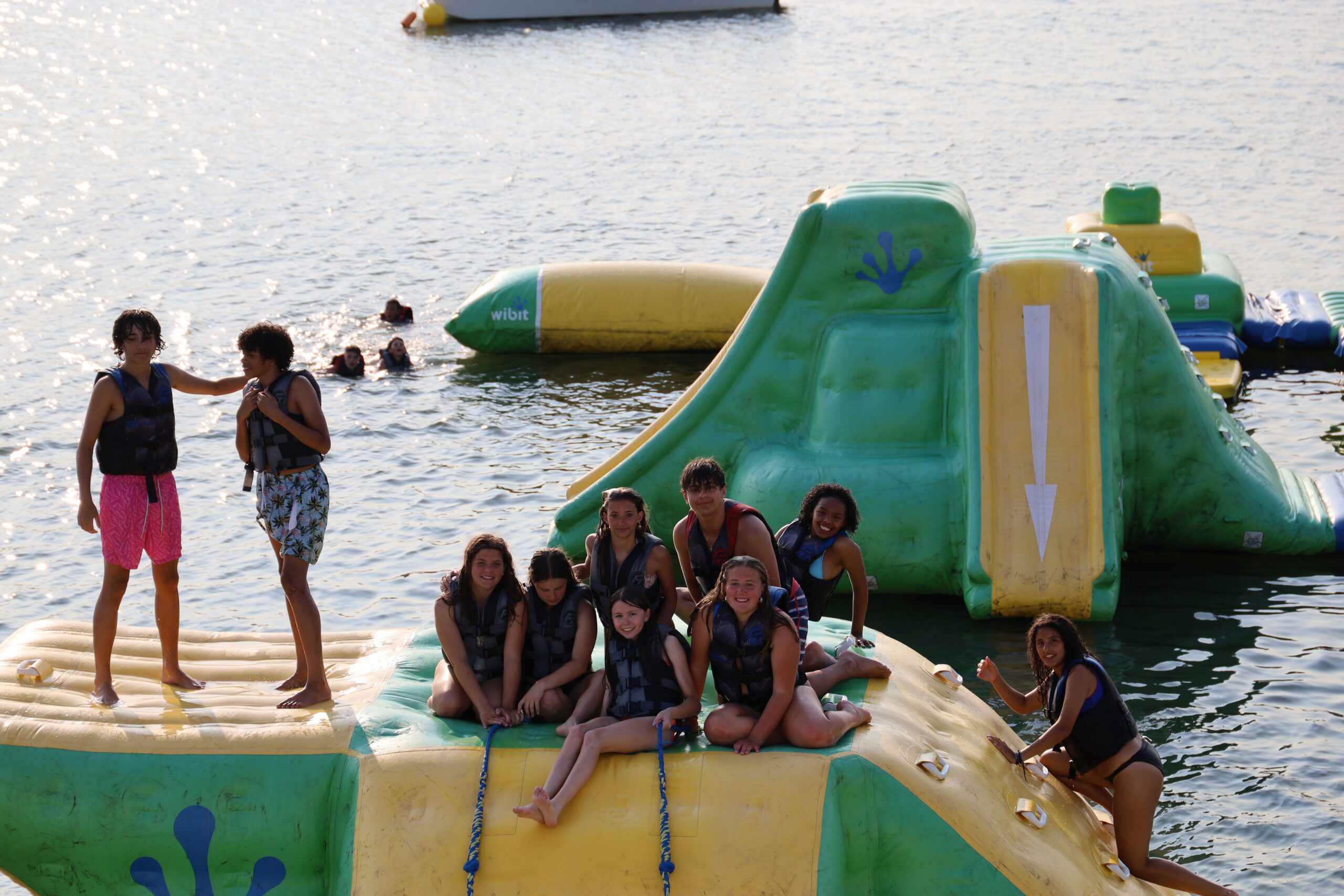 Group of guests huddled together smiling for a photo on top of the aqua park tower during a Private Park Night in Stone Harbor, NJ