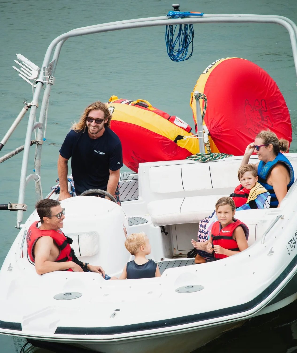 Captain helping a guest with water skis on an Island Water Sports ski boat session in Stone Harbor.