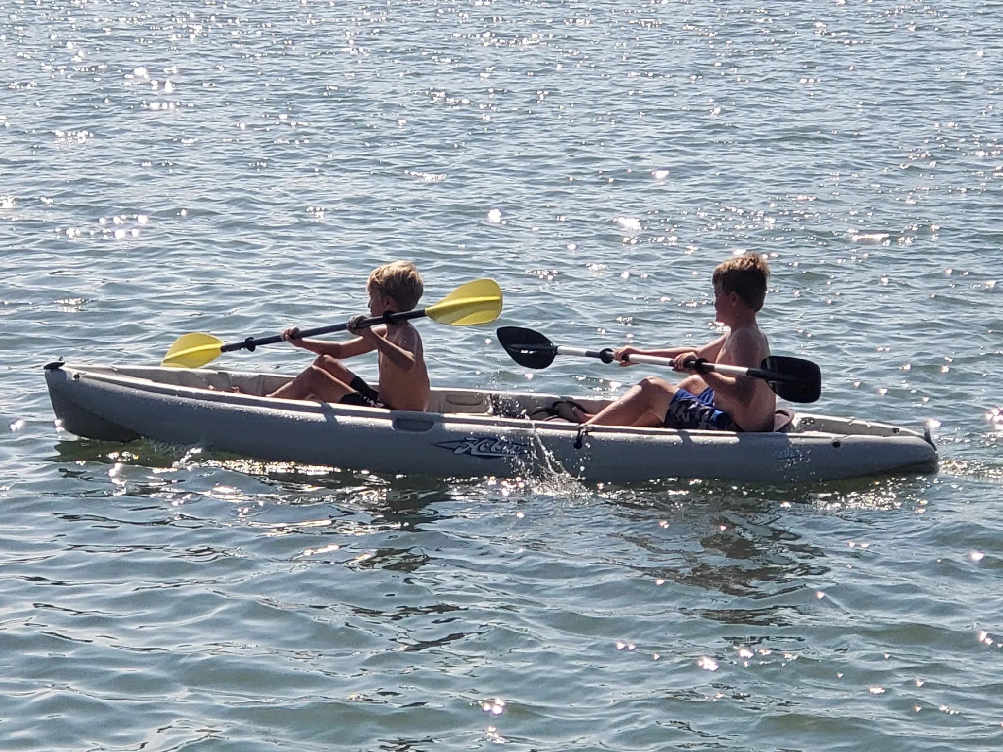 Two kids laughing and having fun on a tandem kayak in Stone Harbor, NJ