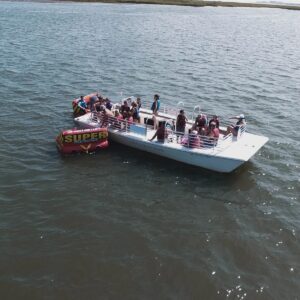Large group tubing and cruising aboard the Island Water Sports 22-passenger boat in the Stone Harbor back bay